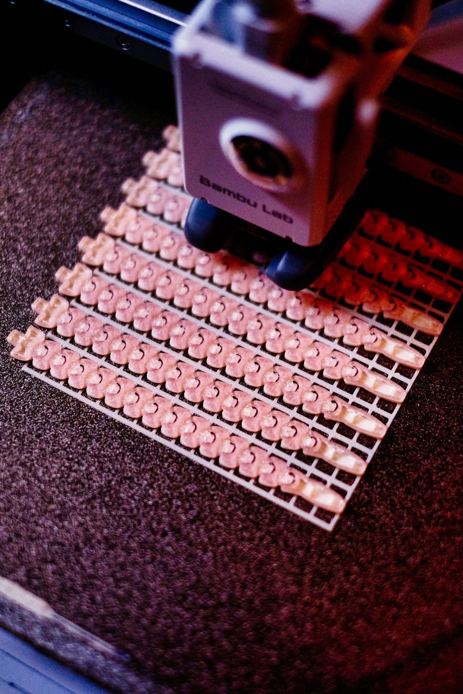 Freshly 3D-printed pieces lined up on the print bed at Elemental Crafts 3D